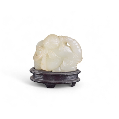 340 - Chinese19th CenturyWhitish mutton fat jade boy and carpProperty of a gentlemanFrom the collection of... 