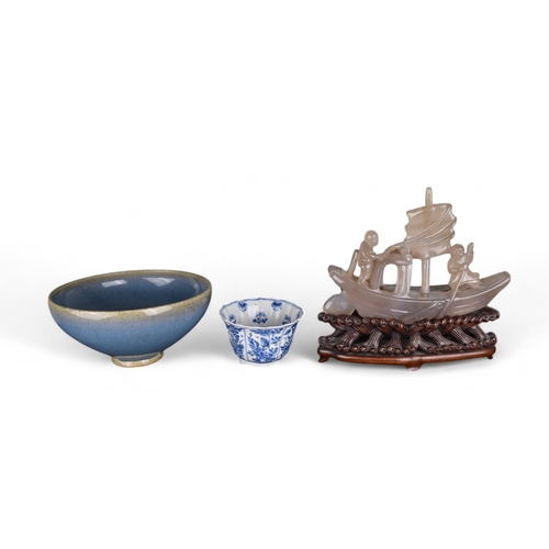 363 - Chinese, c. 1920A chalcedony model of a boat on an intricately carved honglu standTogether with a Ch... 