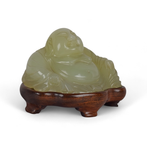 365 - ChineseLate Qing DynastyA seated jade Buddha on a later wooden standProperty of a gentlemanFrom... 