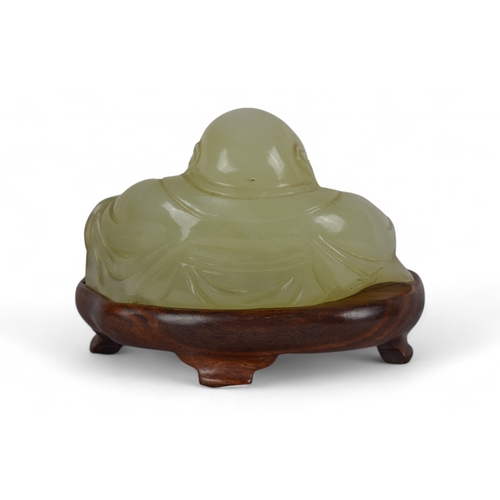 365 - ChineseLate Qing DynastyA seated jade Buddha on a later wooden standProperty of a gentlemanFrom... 