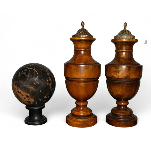 669 - A pair of treen urns with decorative lids, together with a hardstone orb on a wooden baseTo be sold ... 