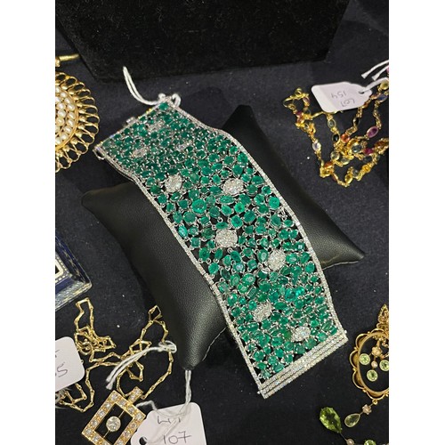 96 - Continental, Circa 1990A highly flexible material-like emerald and diamond bracelet.The wide bracele... 