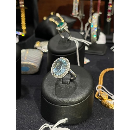 110A - ContinentalContemporaryAn aquamarine and diamond ringThe oval mixed cut aquamarine weighing approxim... 