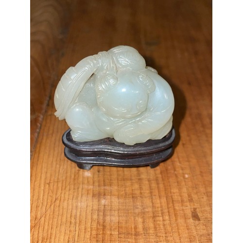 340 - Chinese19th CenturyWhitish mutton fat jade boy and carpProperty of a gentlemanFrom the collection of... 