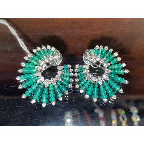 132 - Continental, ContemporaryA pair of emerald and diamond fan-shaped ear clips.Set through with emerald... 