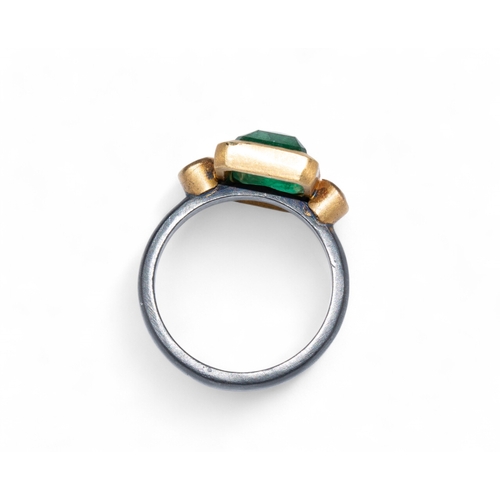 111 - Brooski, ContemporaryA rectangular cut emerald and diamond ring. The rectangular cut emerald with pa... 