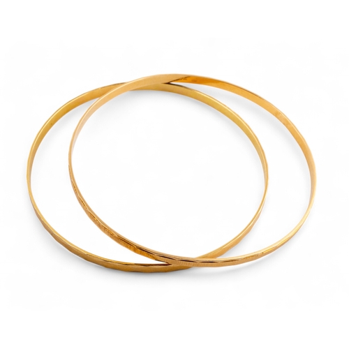 15 - Continental, 1980sTwo yellow metal bangles, stamped 750. Approximate weight 17 grams