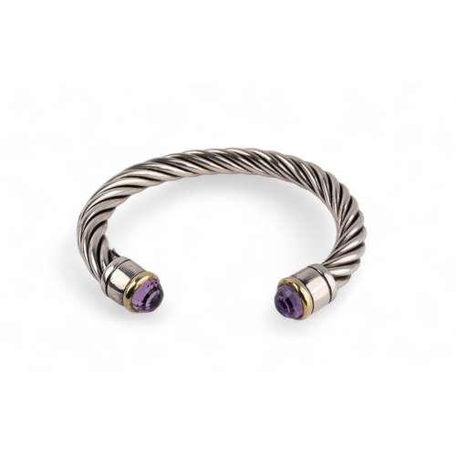 34 - ContemporaryA group of three silver twist gold and gem set bangles. The terminals set with topaz, ci... 