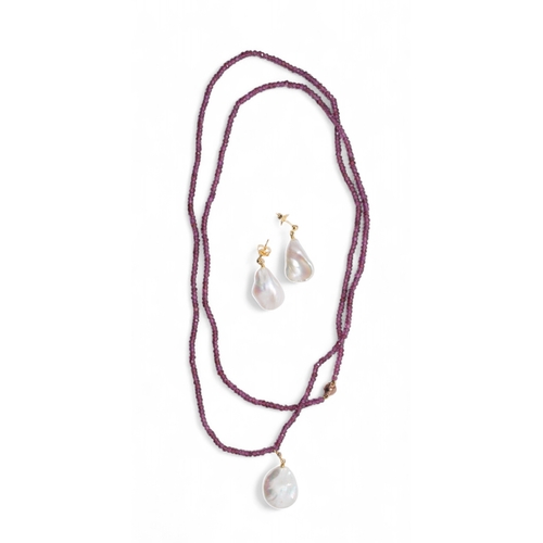 35 - A cultured pearl, 18 carat gold and diamond bead pendant on a faceted garnet bead necklace and a pai... 