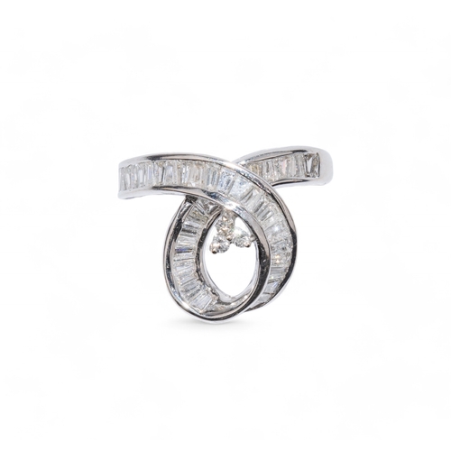 4 - ContemporaryAn 18 carat white gold and diamond swirl dress ring, calibre set, with baguette cut diam... 