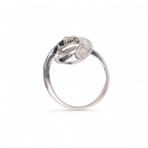 4 - ContemporaryAn 18 carat white gold and diamond swirl dress ring, calibre set, with baguette cut diam... 