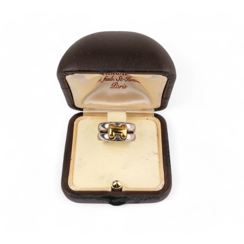 58 - Hermès, c. 1980sA gold and silver dress H ring, signed. In its box and outer box. Size I 1/2.... 