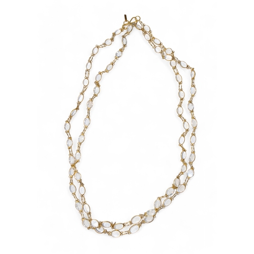 89 - ContemporaryA collet-set 14k gold and moonstone long chain necklace. Set with sixty-four slightly gr... 