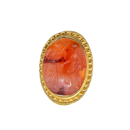 93 - Ancient (?)A carnelian intaglio mounted in a heavy 18k gold beadwork and wire twist mount as a ring.... 