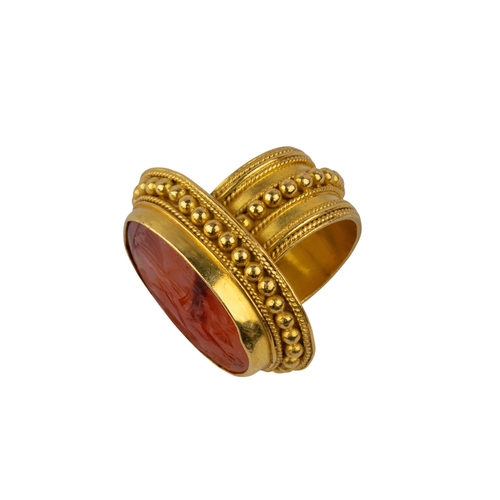 93 - Ancient (?)A carnelian intaglio mounted in a heavy 18k gold beadwork and wire twist mount as a ring.... 