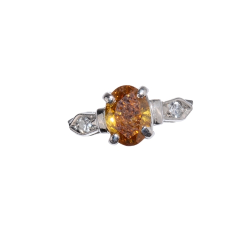 96 - American, circa 1960sA fancy coloured brown diamond ring. The oval shaped diamond weighing approx. 1... 