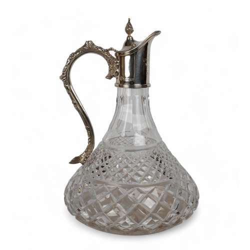 203 - A crystal and silver decanterThe handle with ornate vine leaves, the lid topped with an acorn finial... 