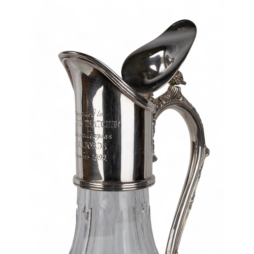 203 - A crystal and silver decanterThe handle with ornate vine leaves, the lid topped with an acorn finial... 