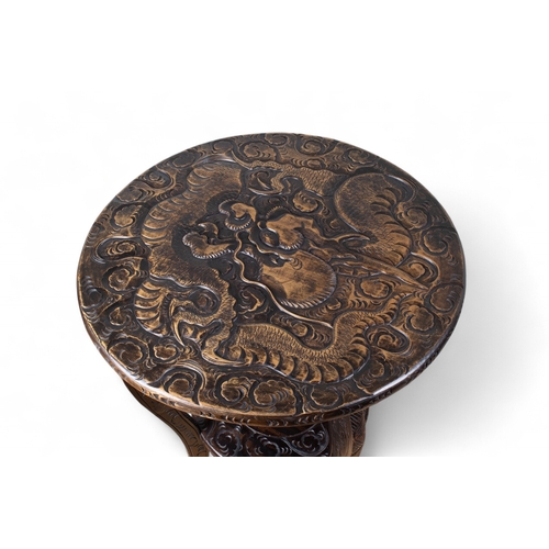 292 - Japanese, 20th centuryA two-tier table with carved dragon designCarved and stained woodDimensions:30... 