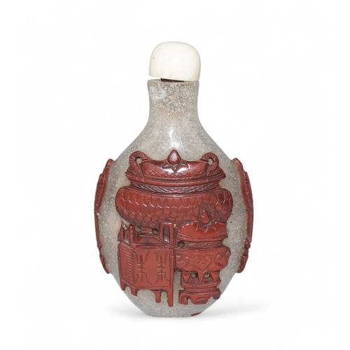 512 - Chinese, Mid 19th centuryA Peking white glass and jasper coloured overlay snuff bottle carved with a... 