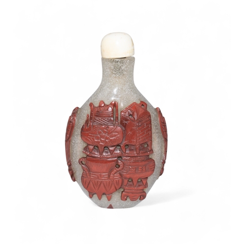 512 - Chinese, Mid 19th centuryA Peking white glass and jasper coloured overlay snuff bottle carved with a... 