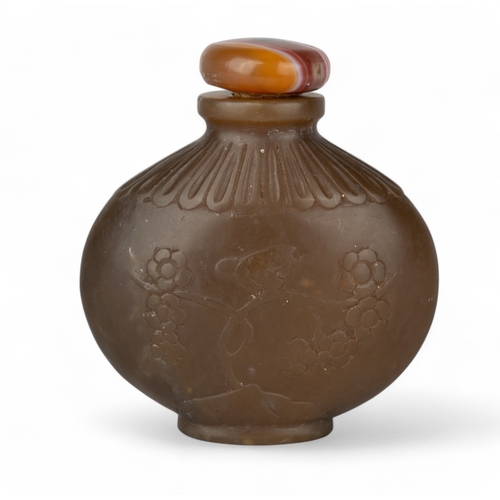 532 - Chinese, Qing dynasty, 18th/19th centuryAn attractive carved brown jade snuff bottle of ovoid squat ... 