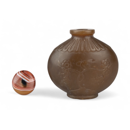 532 - Chinese, Qing dynasty, 18th/19th centuryAn attractive carved brown jade snuff bottle of ovoid squat ... 