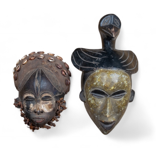 533 - West African, Antique, Two masks to include:[a] Ivory Coast, mask with seashell ornament[b] Nigeria,... 