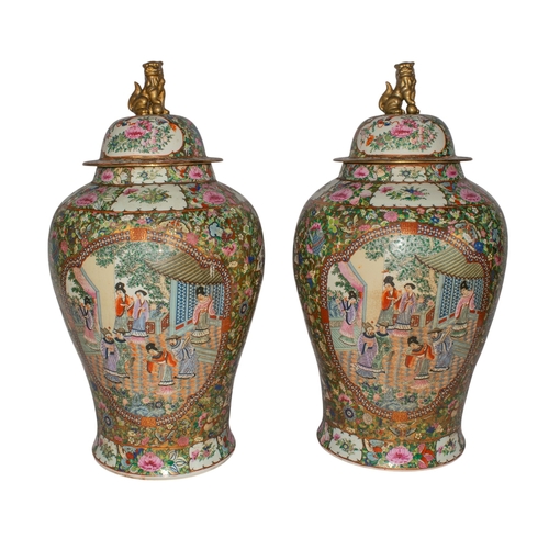 537 - Cantonese20th centuryA pair of famille rose large baluster urns. With birds, butterflies and floral ... 