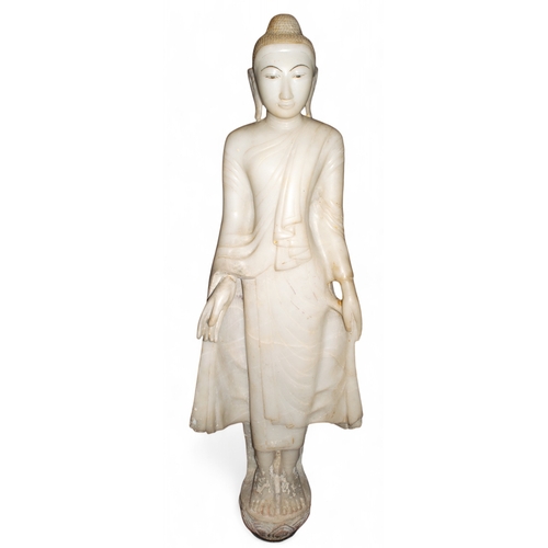 541 - Thai, 19th centuryA large carved painted and gilded white marble standing Buddha on a Lotus flower.D... 