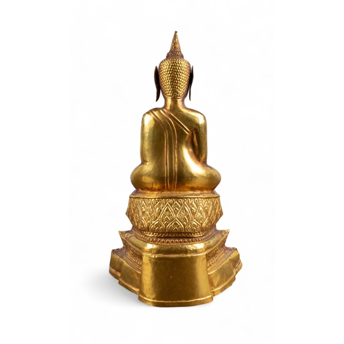 544 - Thai, 19th century (?)An elegant beaten gold and wood carved seated Buddha. The wood covered in a hi... 