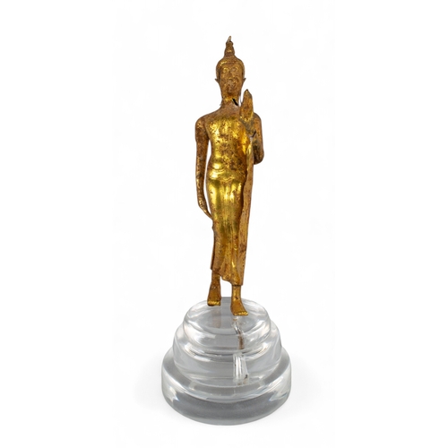 545 - Thai, 17th/18th century (?)A gold walking Buddha, with later perspex stand showing signs of being bu... 