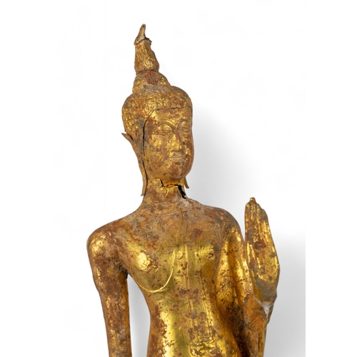 545 - Thai, 17th/18th century (?)A gold walking Buddha, with later perspex stand showing signs of being bu... 