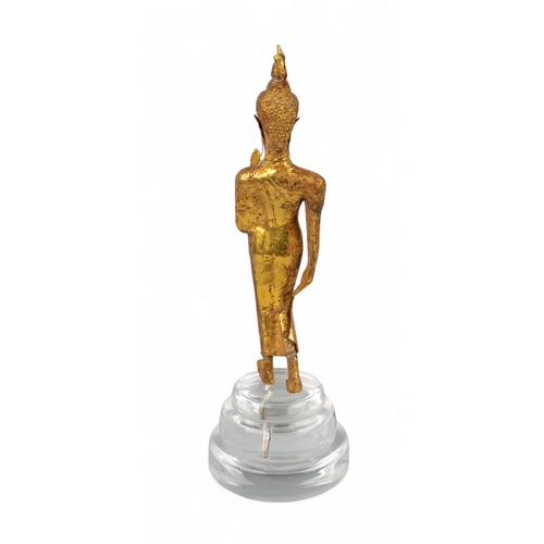 545 - Thai, 17th/18th century (?)A gold walking Buddha, with later perspex stand showing signs of being bu... 