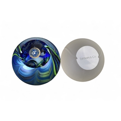 649 - Tiffany & Co.A frosted glass paperweight in the form of a tennis ball, signed 'Tiffany & Co'... 