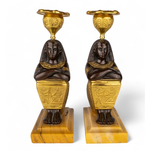 656 - French, circa 1800A pair of Egyptian Revival bronze and ormolu candlesticks in the form of seated fi... 