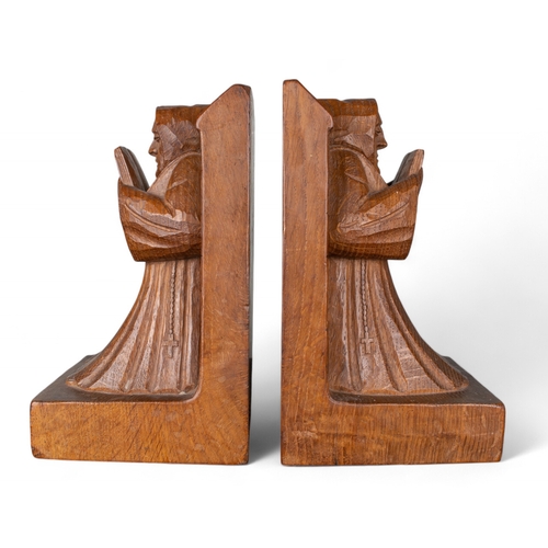 676 - A pair of Robert 'Mouseman' Thompson oak bookends carved as monks reading whilst leaning against wal... 