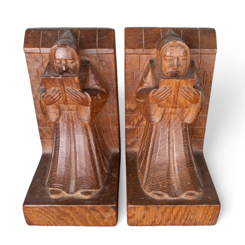 676 - A pair of Robert 'Mouseman' Thompson oak bookends carved as monks reading whilst leaning against wal... 