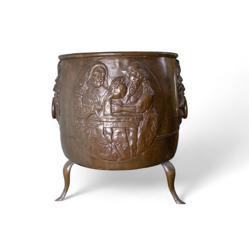 679 - A large bronze cauldron with neoclassical face decorations and three hoof feetProperty of ... 