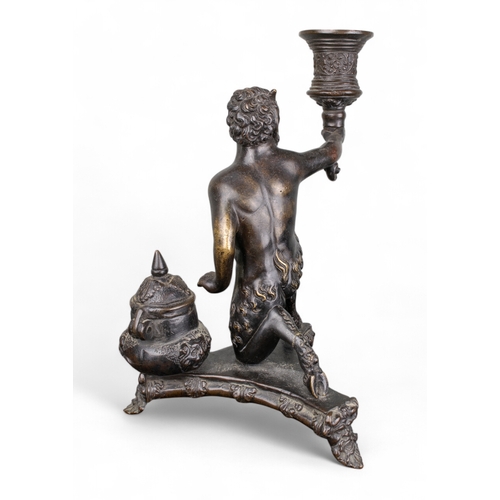 683 - Italian16th century and laterA bronze inkstand in the form of a kneeling satyr holding a torch. The ... 