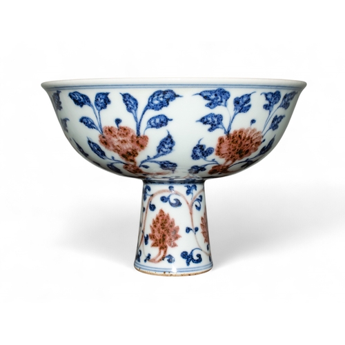 731 - Chinese, 19th centuryA Ming style underglaze blue and red stem bowl. The interior painted with peach... 