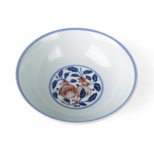 731 - Chinese, 19th centuryA Ming style underglaze blue and red stem bowl. The interior painted with peach... 