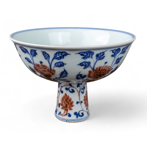 731 - Chinese, 19th centuryA Ming style underglaze blue and red stem bowl. The interior painted with peach... 