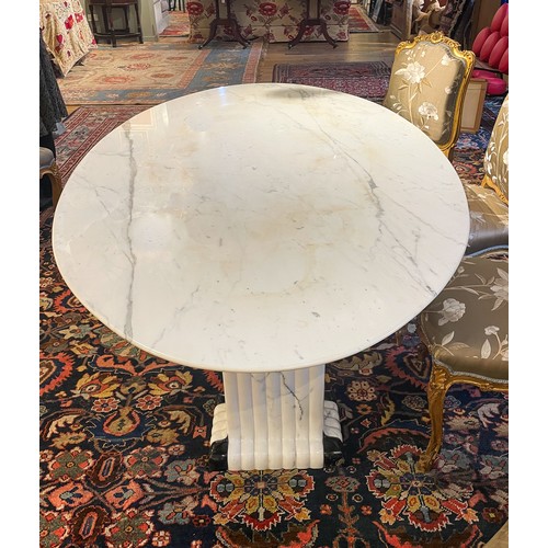 248A - ContemporaryA large oval marble table on two fluted black and white marble columnsDimensions:27.5 in... 