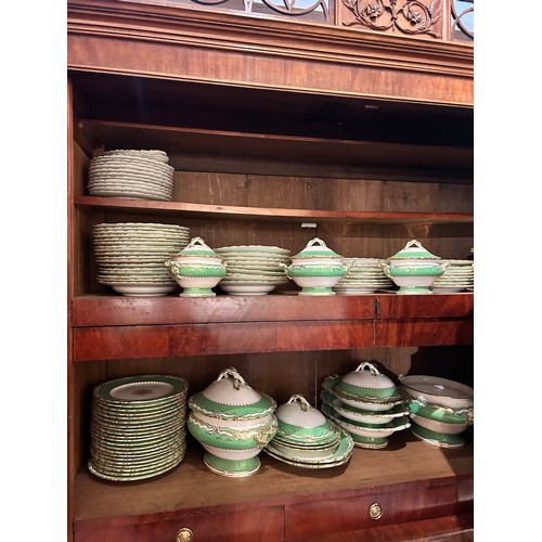 733 - A Rockingham china dinner set with green borders and gilt decoration.To include:[a] Four small turee... 