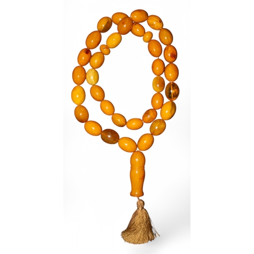 101 - An important and enormous butterscotch amber and amber prayer bead necklaceComprising of 36 large be... 