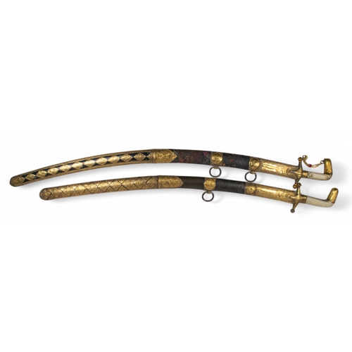 126 - 19th centuryTwo presentational Omani high carat gold clad leather swords, with bone handles.(Acid te... 