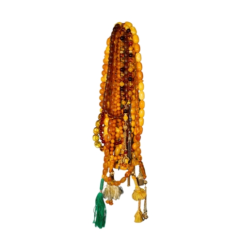 72 - A group of six butterscotch amber prayer bead necklaces and five reconstituted amber prayer bead nec... 