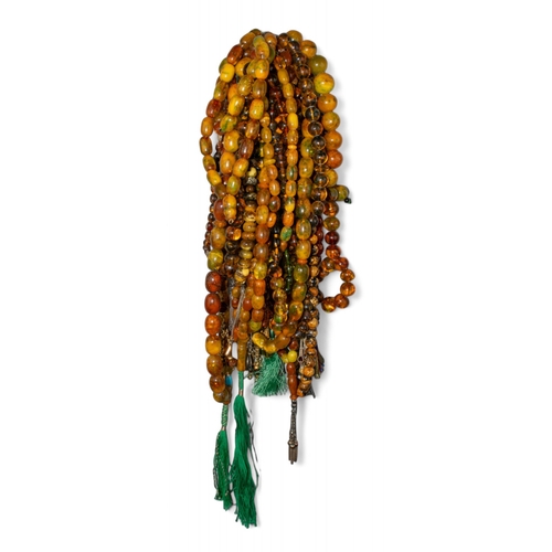 78 - A large collection of reconstituted amber, bakelite and other material prayer bead necklacesProperty... 