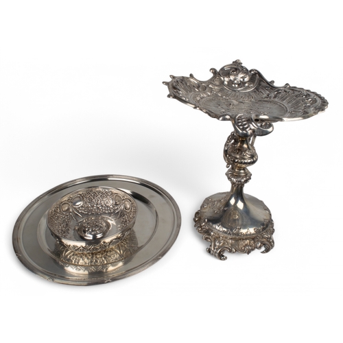 187 - A mixed lotTo include:[a] Turkish (?), white metal/silver (?) tazza[b] A silver ribbon and floral re... 